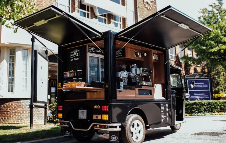 Tuk Tuk de carga transformado num café com as portas abertas.